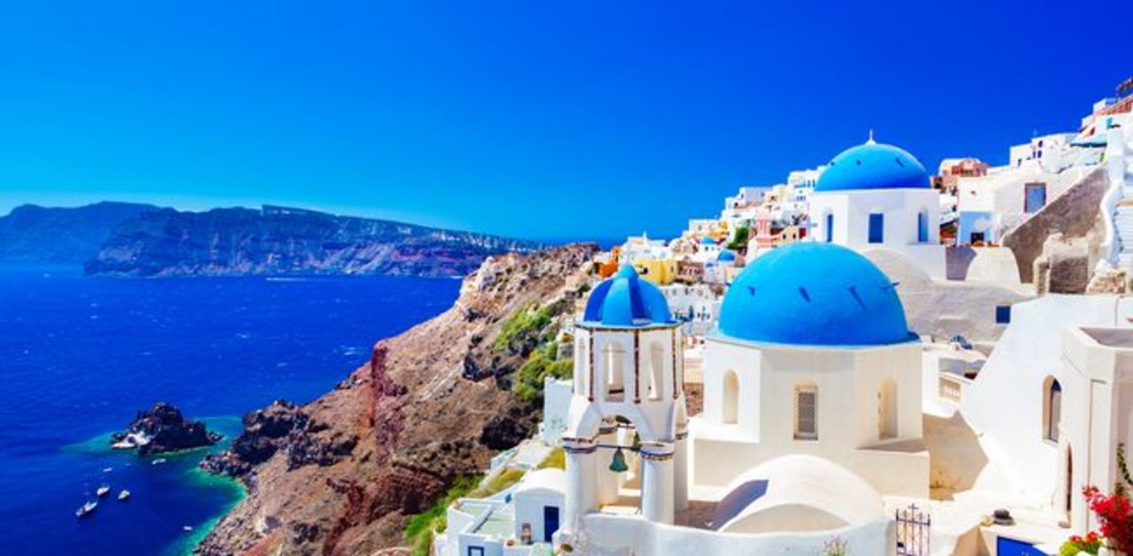 white house with blue roof in santorini